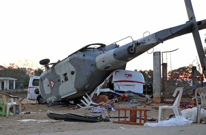 TOPSHOT - View of the remains of the military helicopter that fell on a van in Santiago...