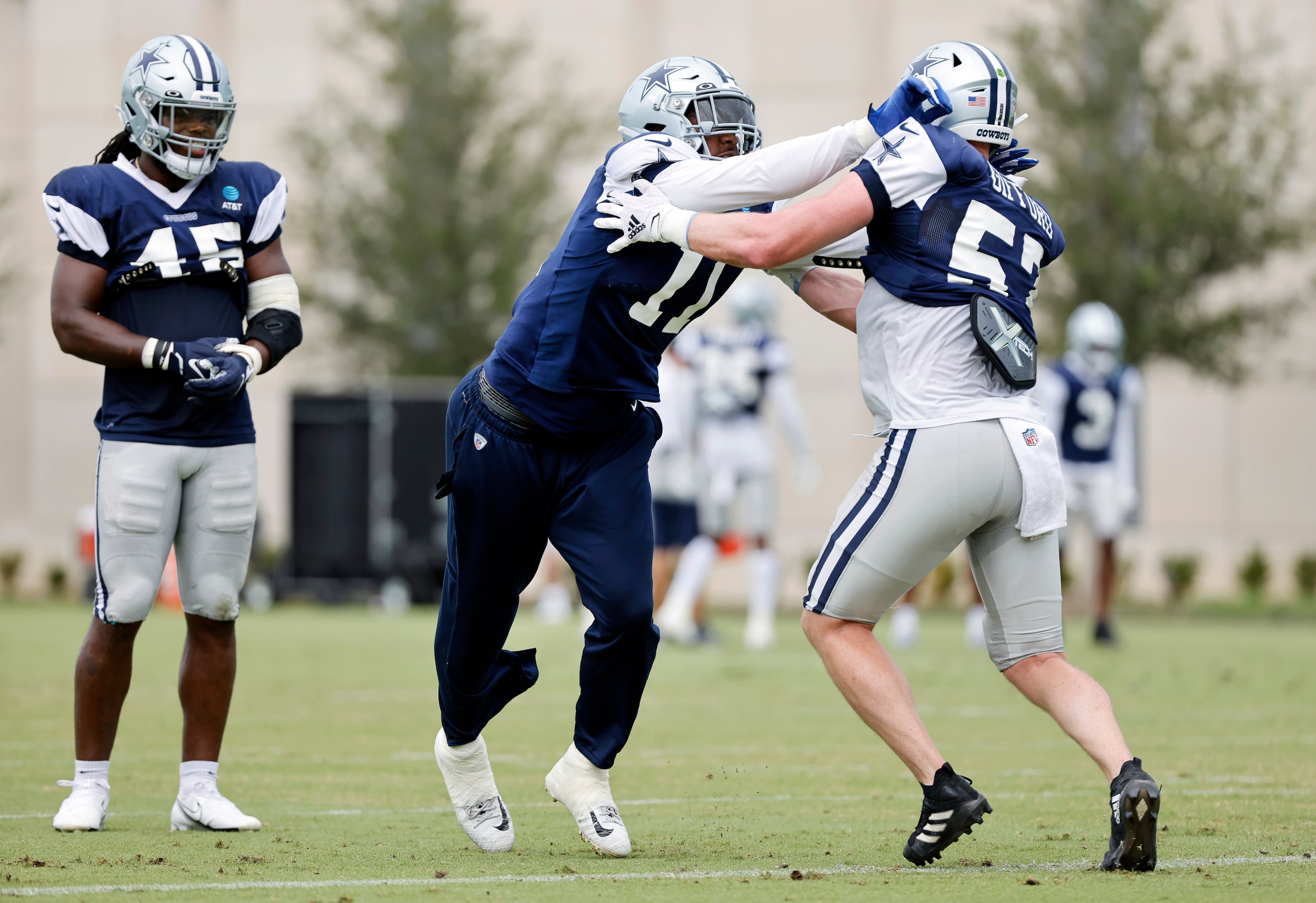 Dallas Cowboys linebacker Micah Parsons (11) pushes off of linebacker Luke Gifford (57) as...