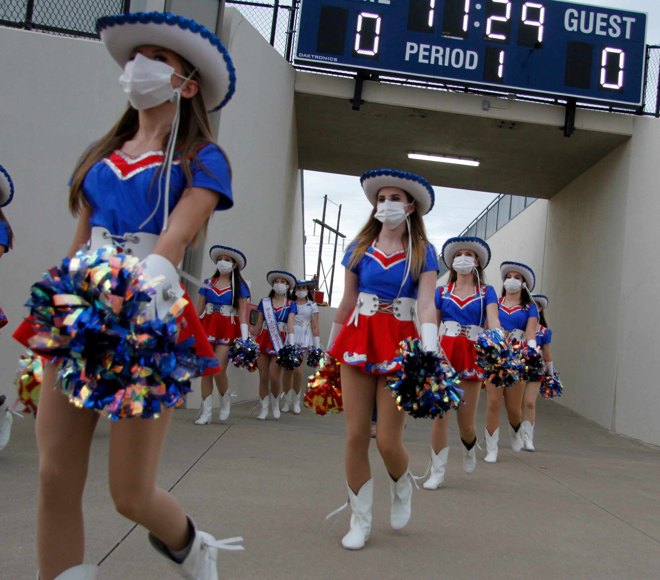 Midlothian Heritage drill team members move onto the field before players emerge through the...