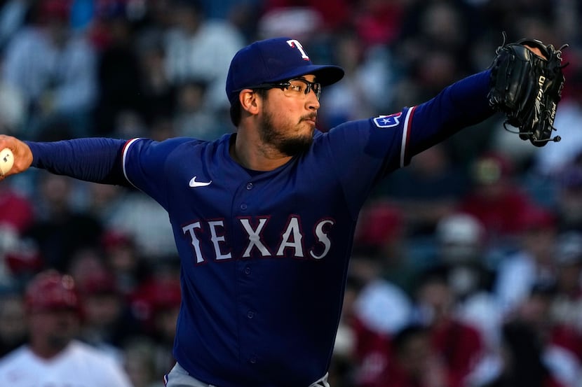 Texas Rangers starting pitcher Dane Dunning throws to the plate during the first inning of a...