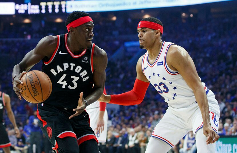 Toronto Raptors' Pascal Siakam, left, looks to make a move against Philadelphia 76ers'...