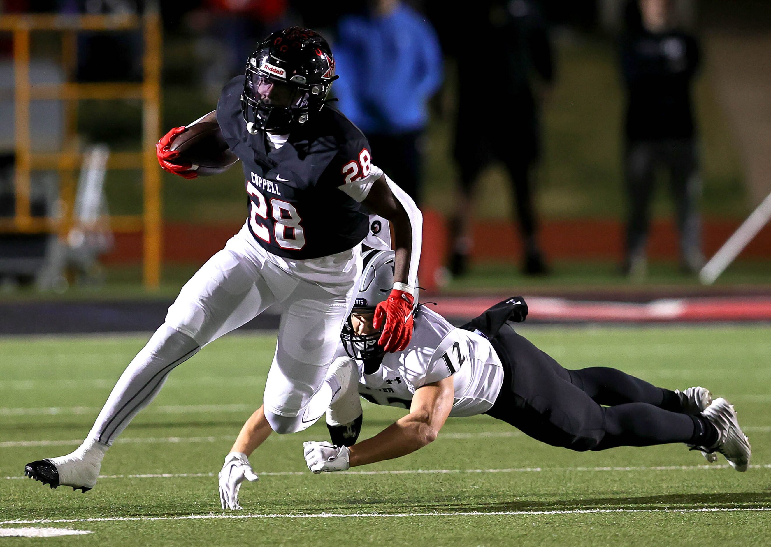 Coppell running back Xavier Mosely (28) breaks a tackle from Denton Guyer defensive back Max...