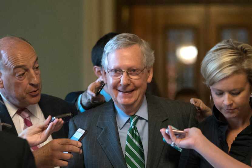 Senate Majority leader Mitch McConnell smiles as he leaves the chamber after announcing the...