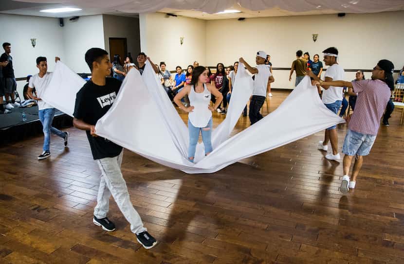 The Latin Boyz Cadets rehearse with Katia Gonzalez, 14 (center) for her quinceañera.