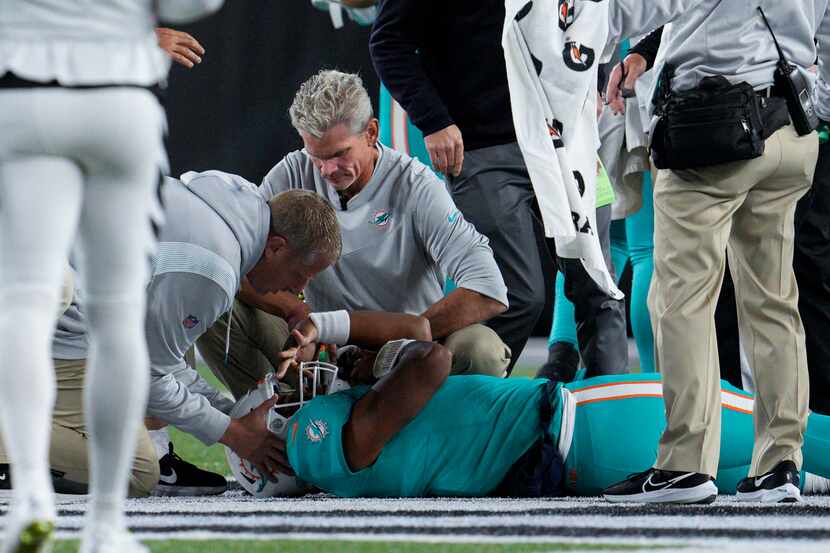 Medical staffers attend Miami Dolphins quarterback Tua Tagovailoa after he was sacked during...