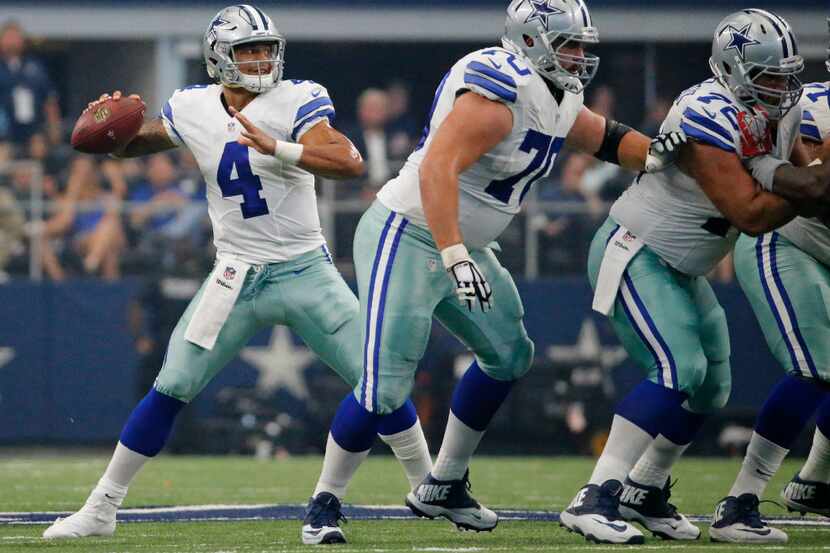 Dallas Cowboys quarterback Dak Prescott (4) throws a pass behind good protection from his...