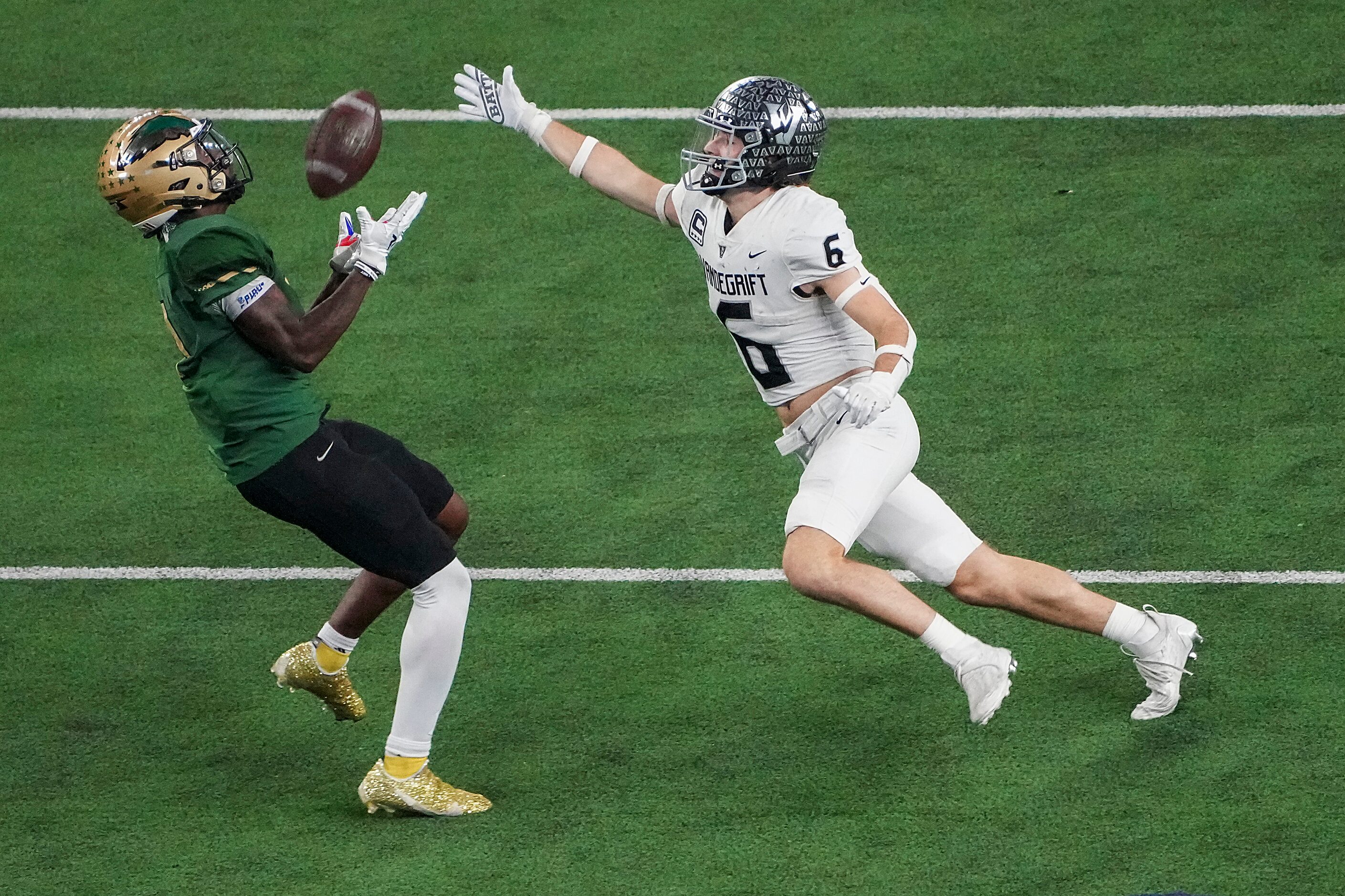 DeSoto wide receiver Johntay Cook (1) hauls in a long pass as Austin Vandegrift defensive...