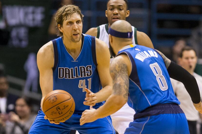 Deron Williams (8)  works the pick and roll with Dirk Nowitzki in Friday's game at...