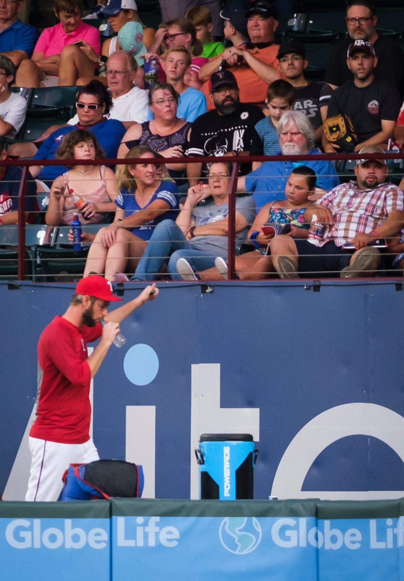 Texas Rangers relief pitcher Chris Martin gives a thumbs up to fans as he leaves the Rangers...