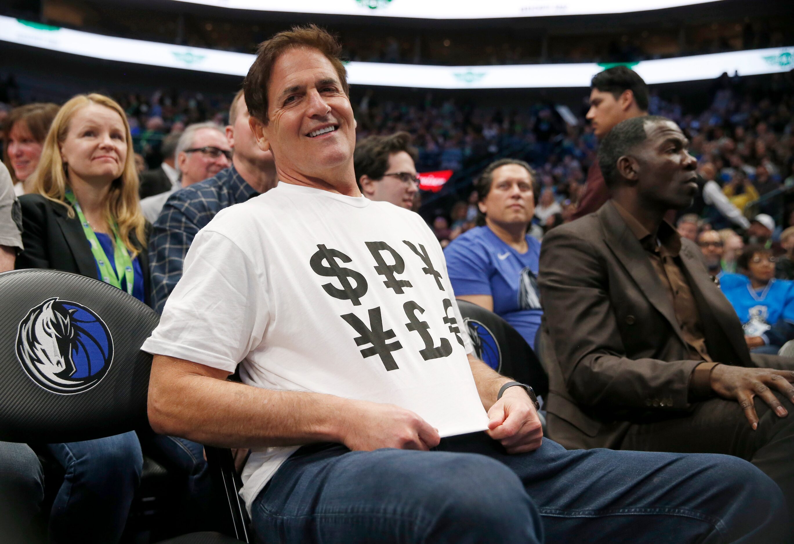 Dallas Mavericks owner Mark Cuban sports a shirt with money signs during the second half of...