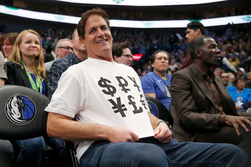 Dallas Mavericks owner Mark Cuban sports a shirt with money signs during the second half of...