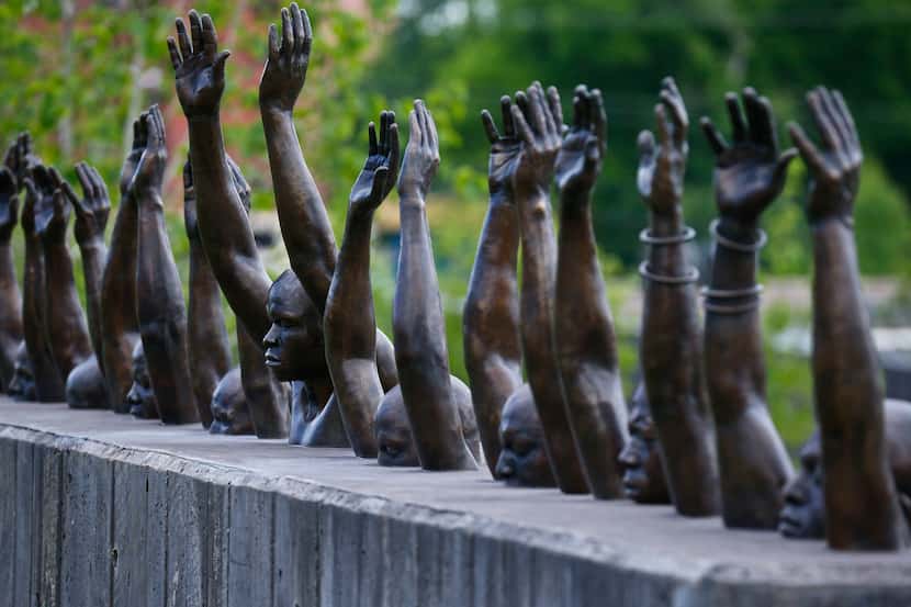 The bronze sculpture Raise Up by Hank Willis Thomas addresses police violence against...