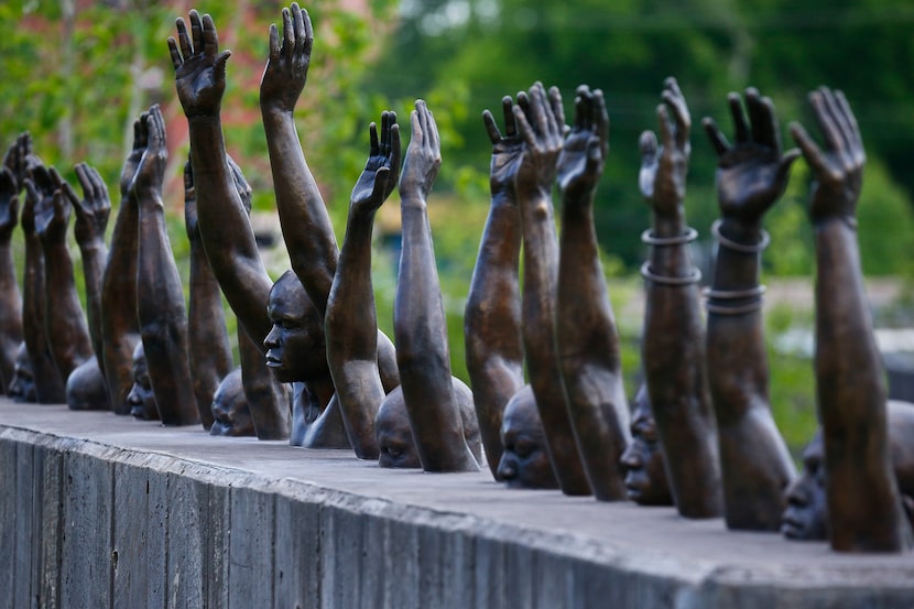 The bronze sculpture Raise Up by Hank Willis Thomas addresses police violence against...