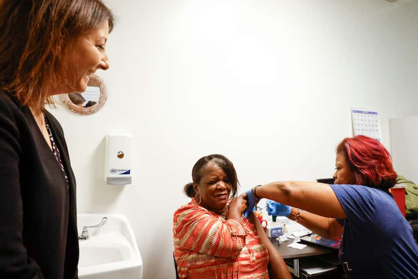 Centers for Disease Control and Prevention director Mandy Cohen (left) watches as Dallas...