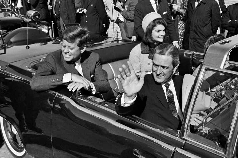 Pres. John F. Kennedy, Jacqueline Kennedy, and Texas Gov. John Connally wave as their...