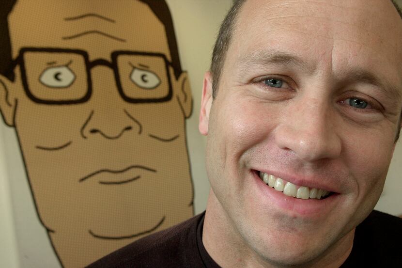 Mike Judge poses in front of an illustration of Hank Hill in 2002 in Los Angeles. Judge and...