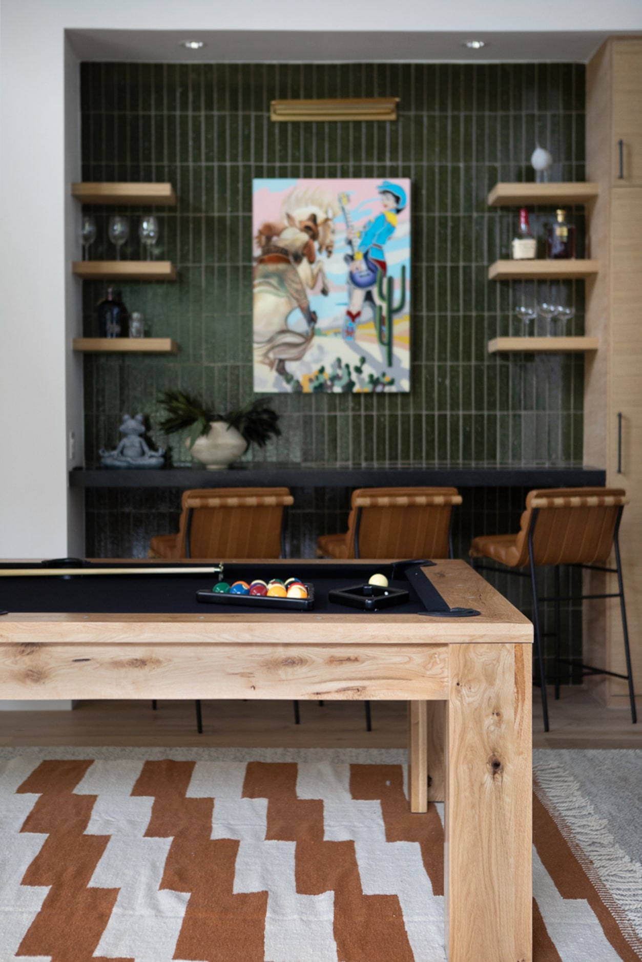 In a game room designed by Ginger Curtis of Urbanology Designs, a pool table has a chic,...