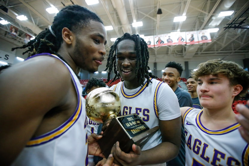 Richardson junior forward Tim Jordan, center, celebrates with his teammates after winning a...