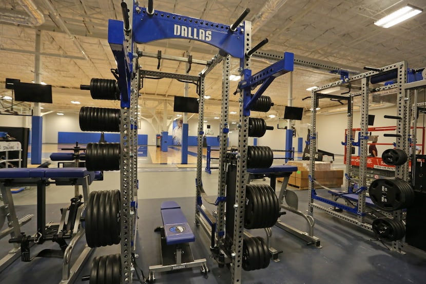 Weight machines stand at the ready at the Dallas Mavericks' new practice facility, which is...