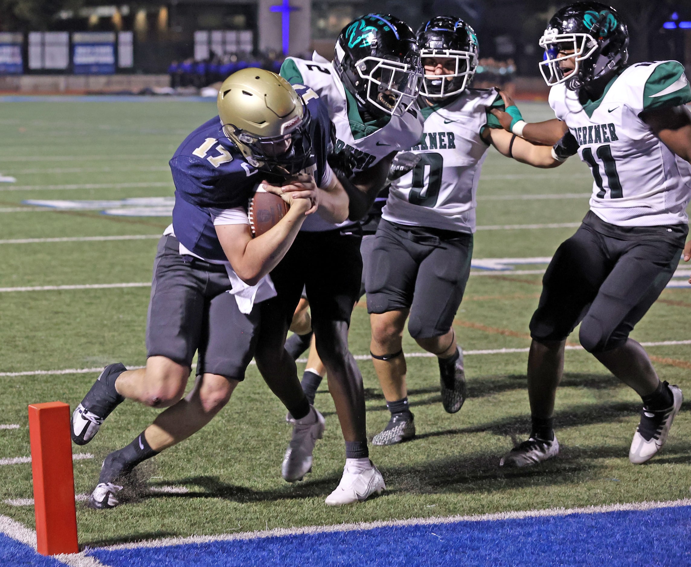 Jesuit QB Charlie Schmidt (17) scores a touchdown, as Richardson Berkner defender Ronnie...