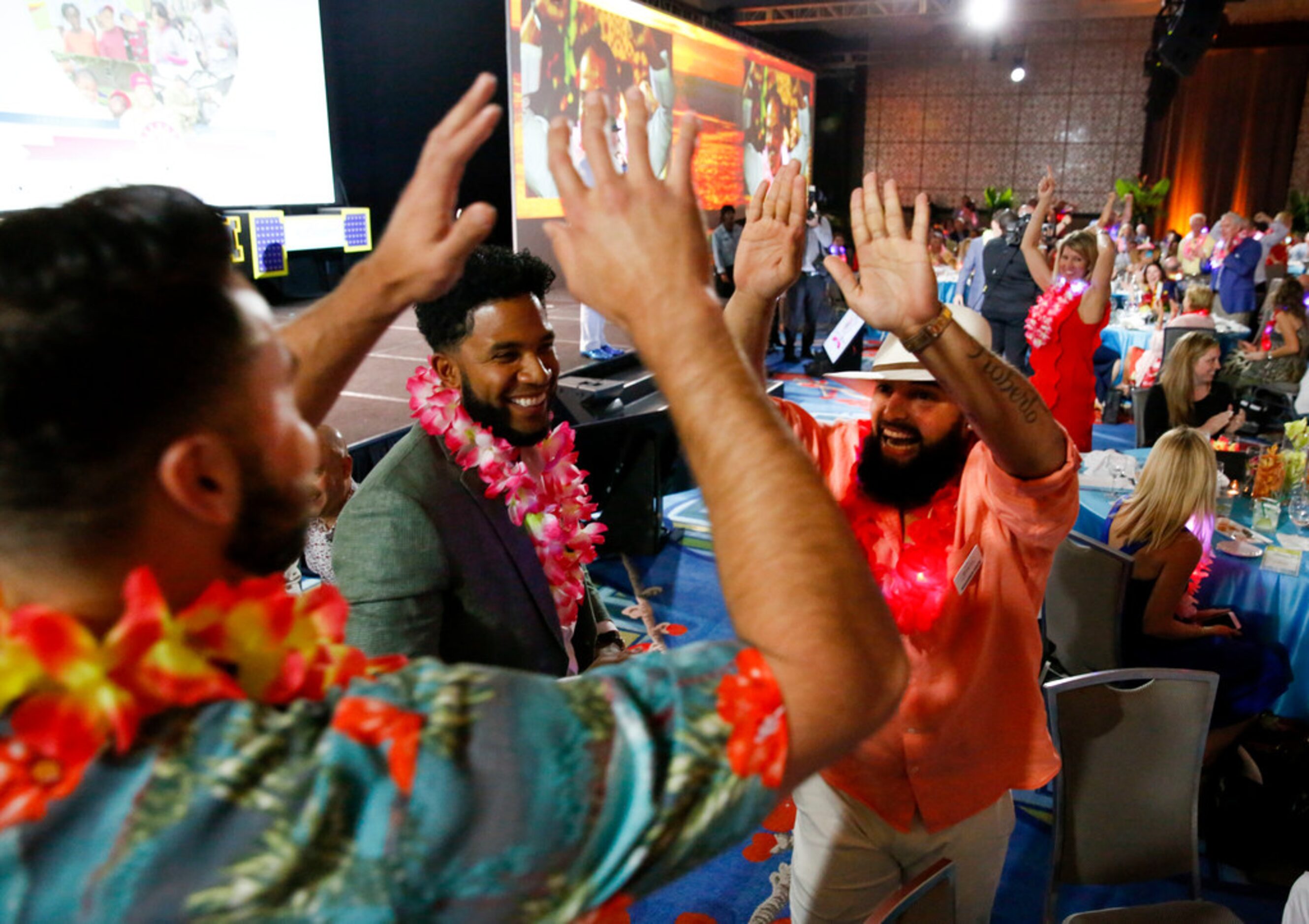 Texas Rangers Joey Gallo (left) Rougned Odor and Elvis Andrus celebrate guessing right while...