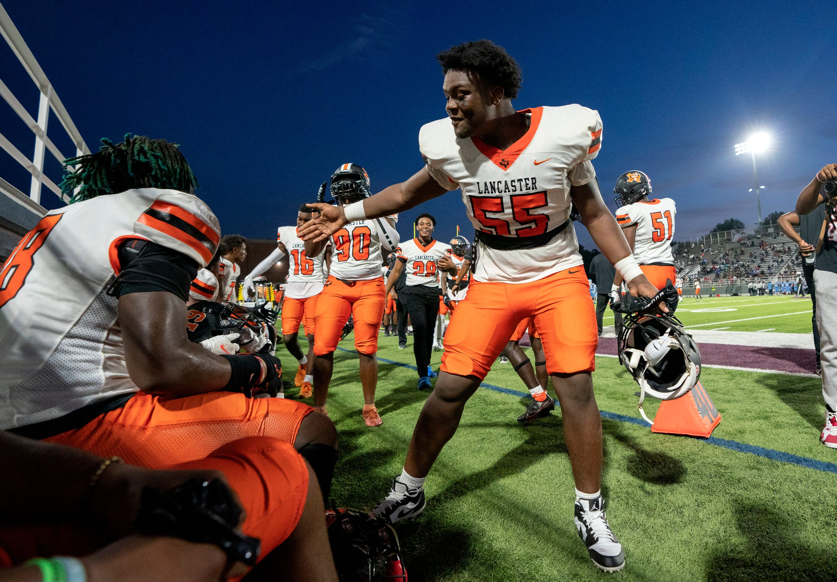 Lancaster offensive lineman De’Anthony Gilmore (55) congratulates linebacker Jarmarcus Piper...