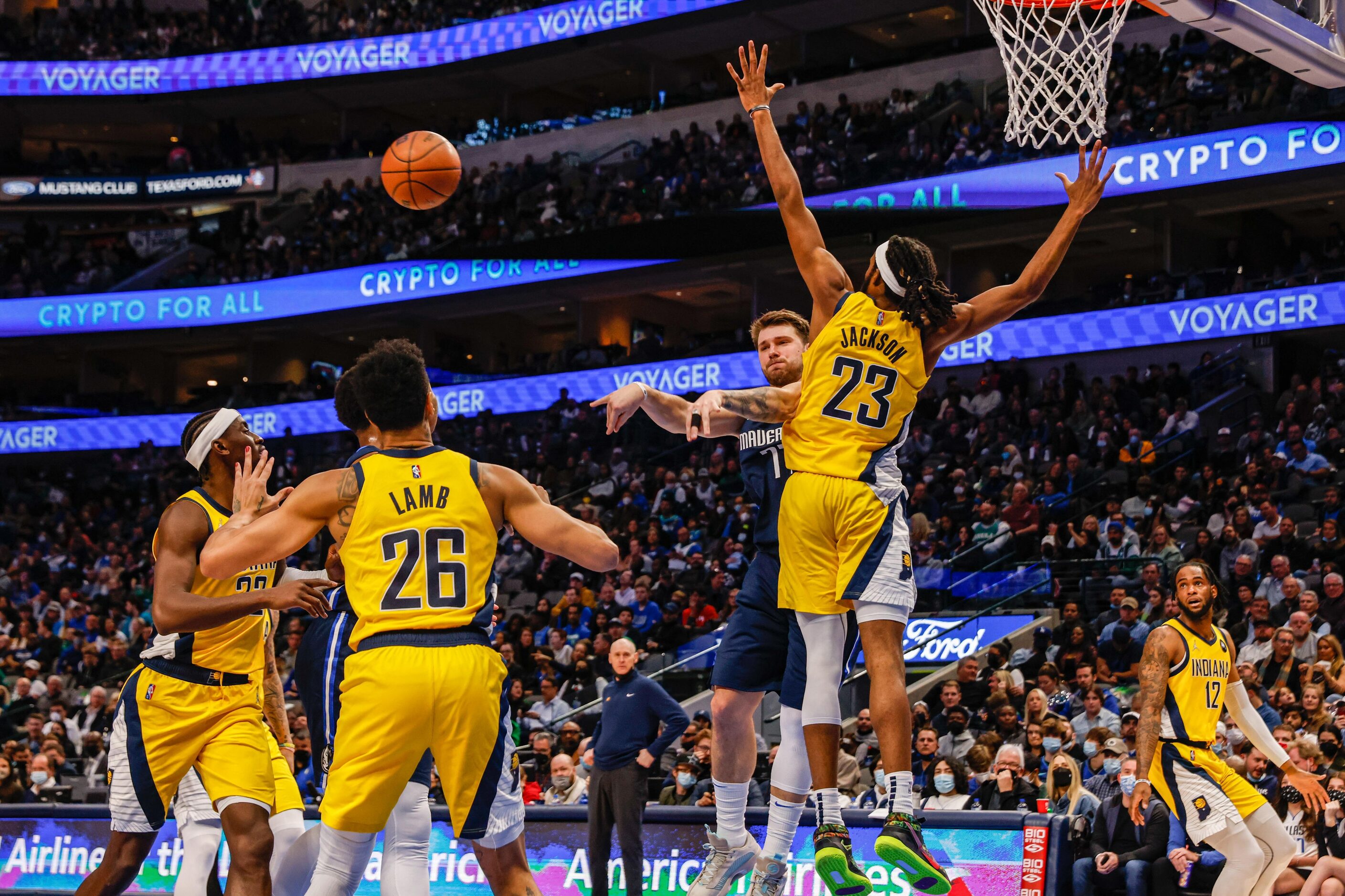 Dallas Mavericks guard Luka Doncic (77) makes a pass through Indiana Pacers guard Jeremy...