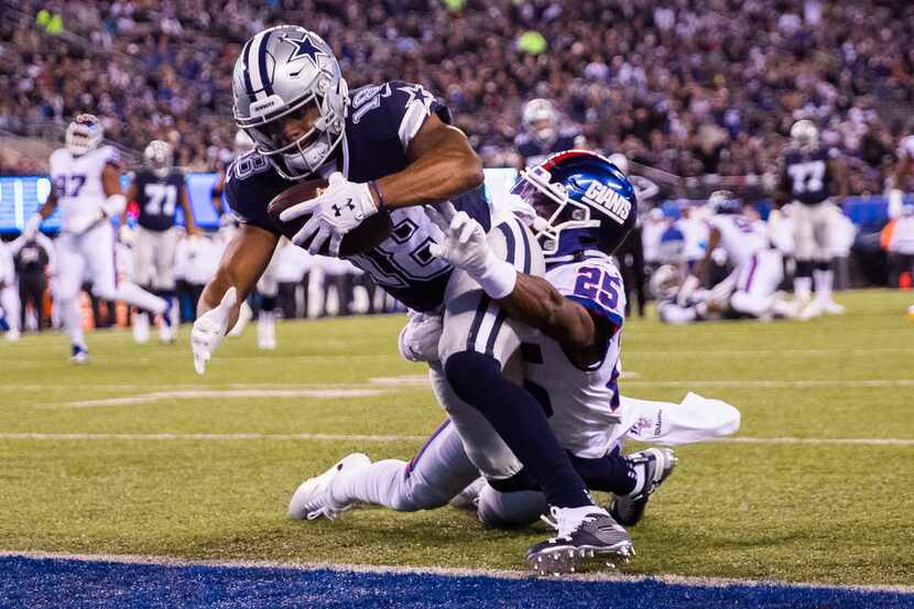 Dallas Cowboys wide receiver Randall Cobb (18) makes it across the goal line while being...