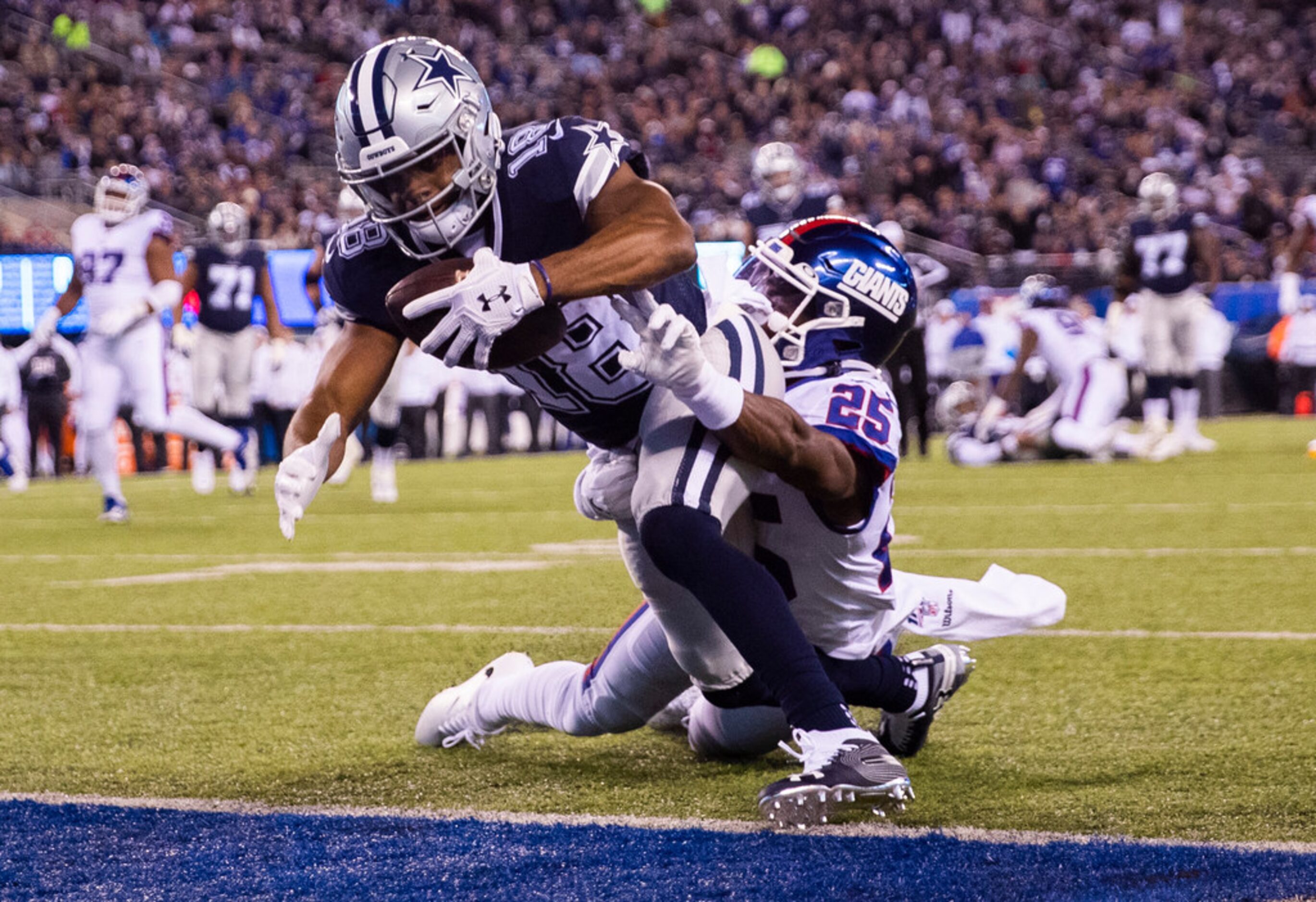 Dallas Cowboys wide receiver Randall Cobb (18) makes it across the goal line while being...