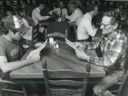 In this Dallas Morning News file photo from 1988, Frank Owen (left) and Pierre Littiere eat...