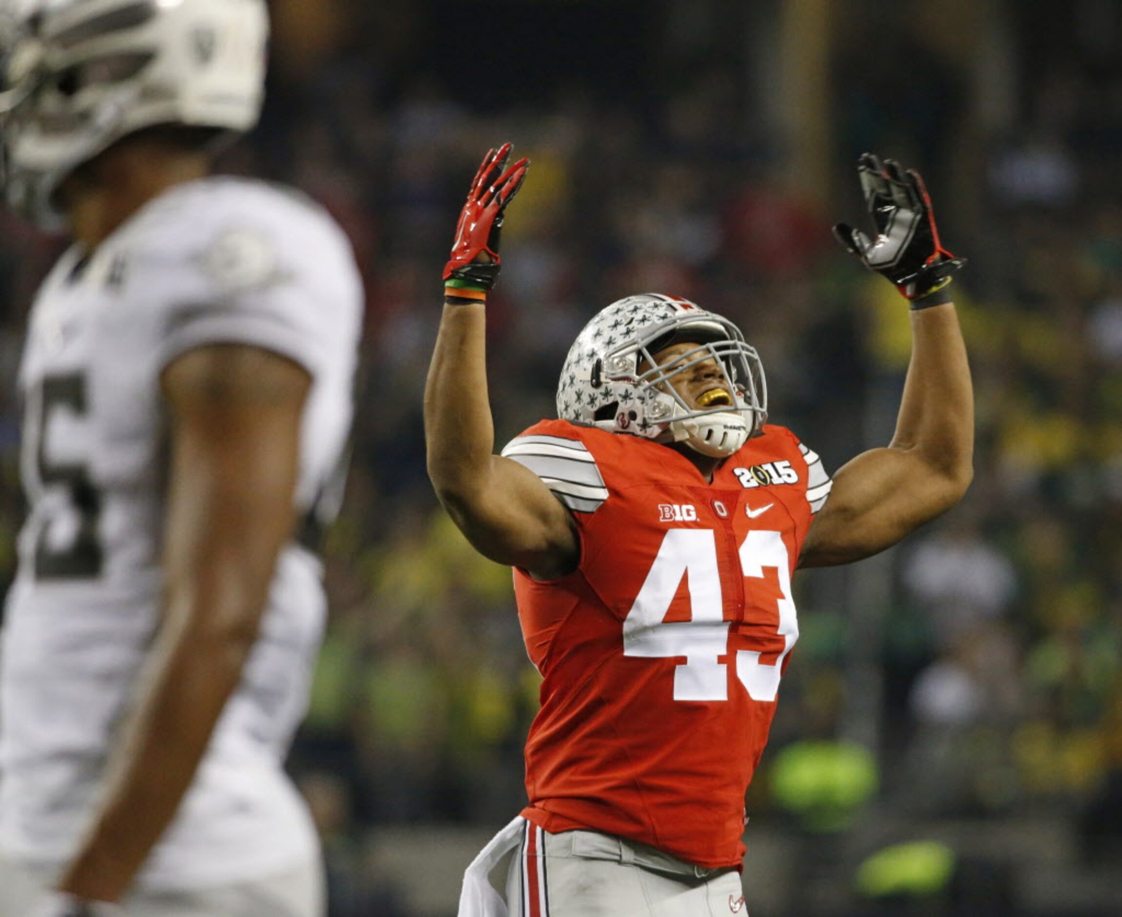 Ohio State Buckeyes linebacker Darron Lee (43) tries to rev up the fans during the second...