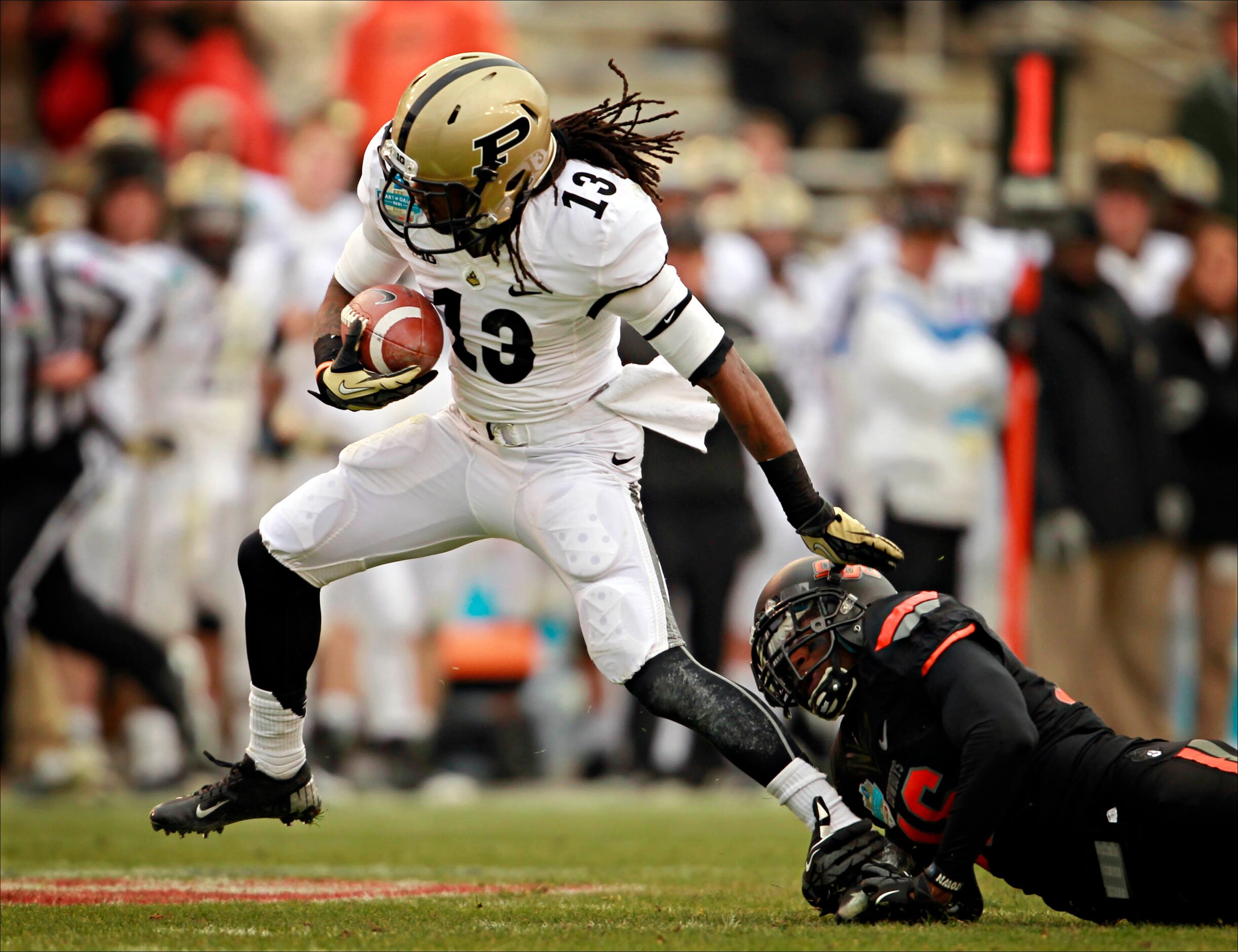 Oklahoma State Cowboys cornerback Andrae May (16) stops a run by Purdue Boilermakers...