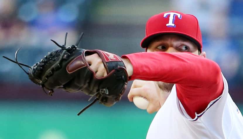 Texas Rangers relief pitcher Tanner Scheppers (52) pitches in the tenth inning during a...