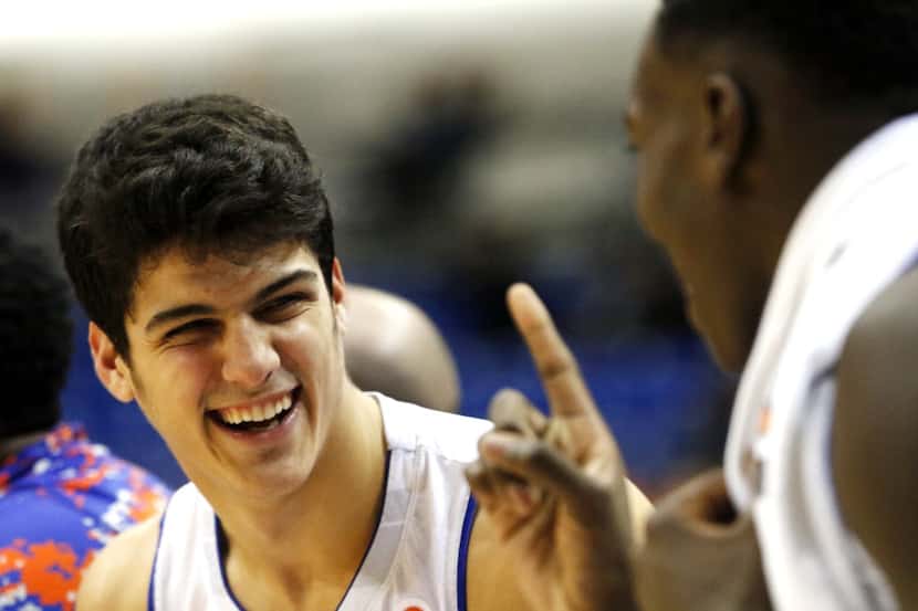 UT-Arlington's Jorge Bilbao smiles while talking with his teammate on the bench during the...
