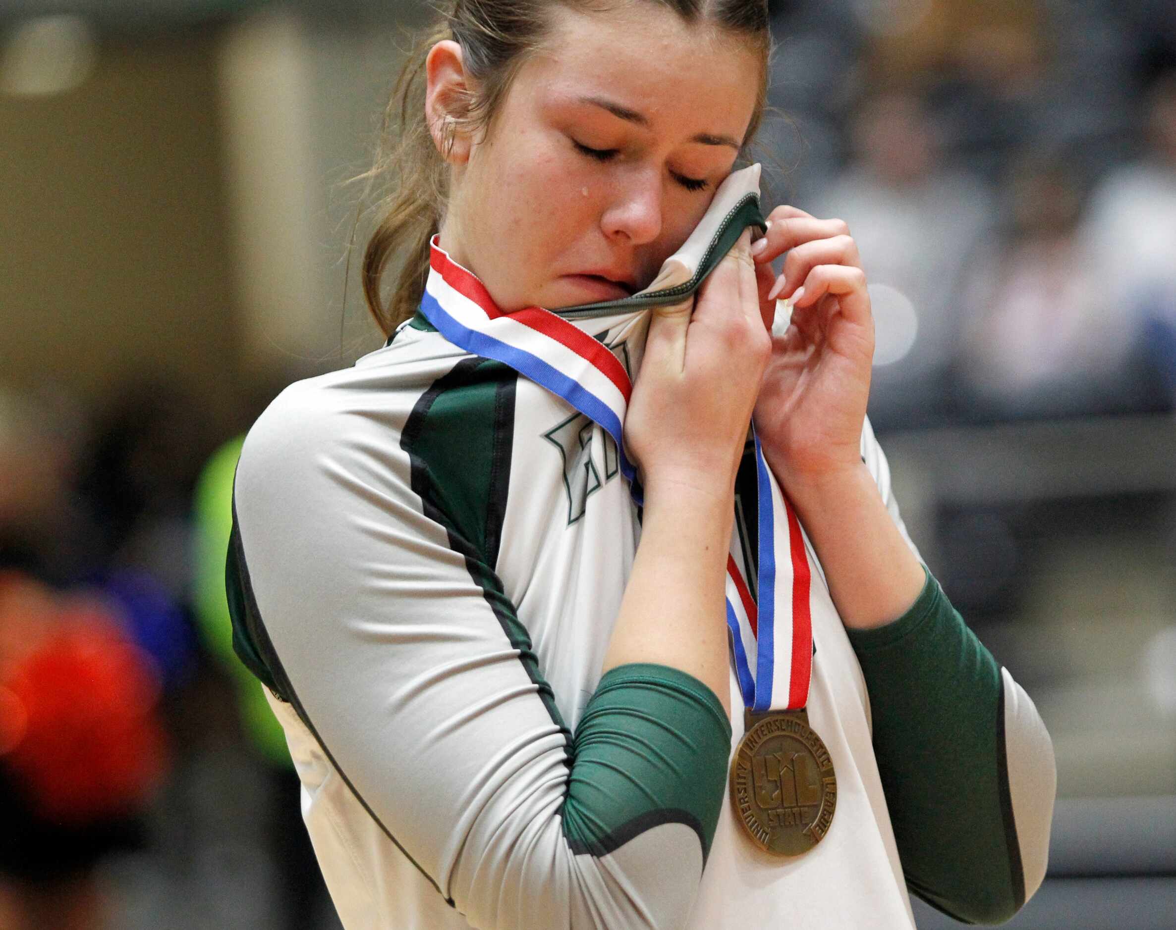 Prosper junior Camilla Cox (11) wipes a tear after receiving her medal following the Eagles'...
