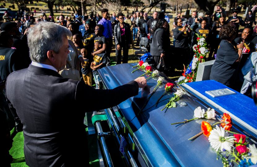 Austin Mayor Steve Adler places a flower on Overton's casket. "It was impossible to be...