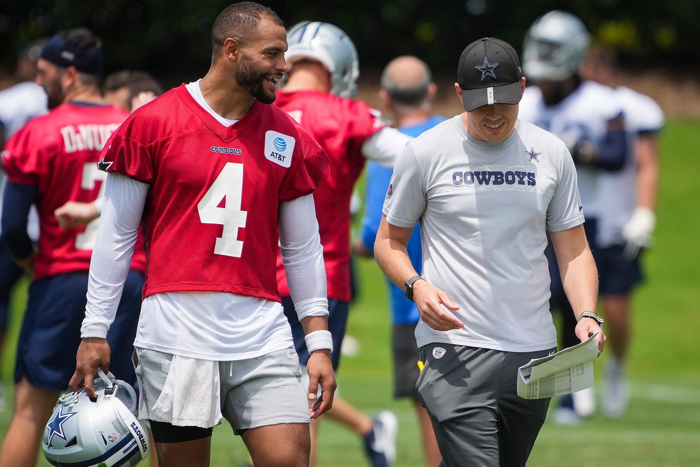 Dallas Cowboys quarterback Dak Prescott (4) talks with offensive coordinator Kellen Moore...