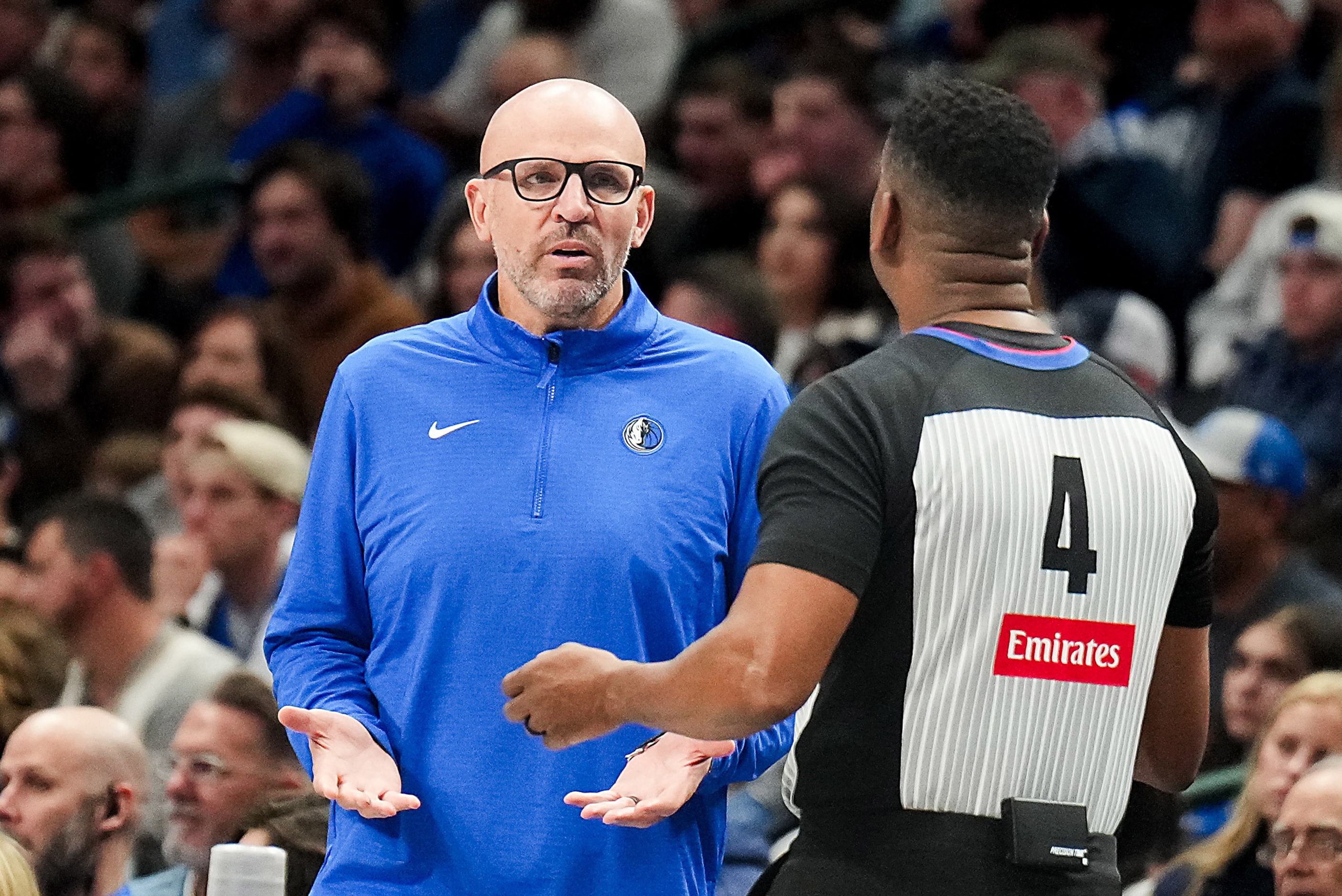 Dallas Mavericks head coach Jason Kidd talks with referee Sean Wright during the first half...