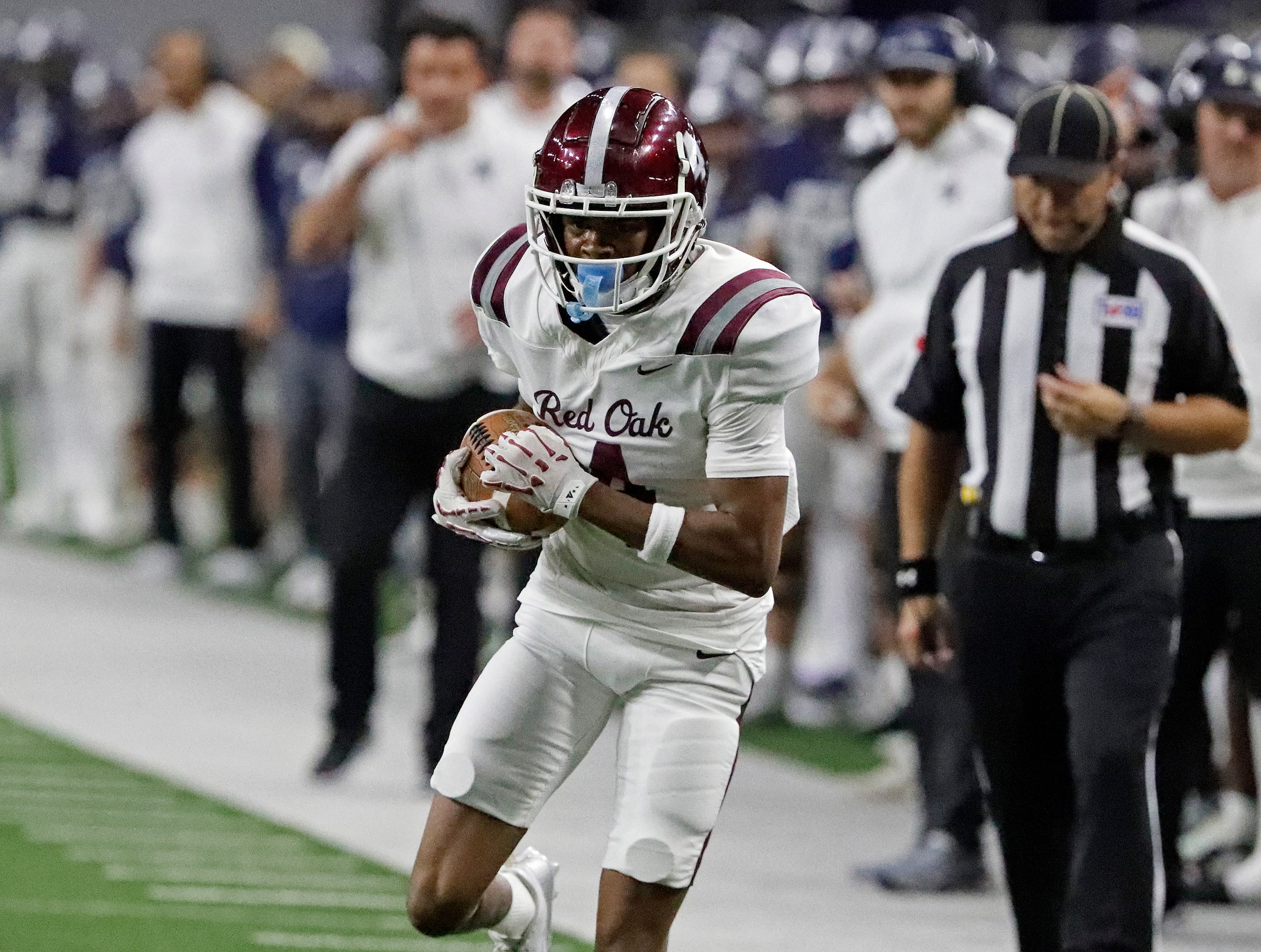 Red Oak High School wide receiver Charles Taplin (4) runs after the catch during the first...