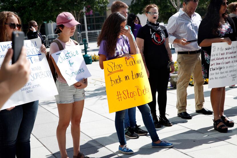 Gaby Tumbaga, 18, center, a student at Georgetown University, protests proposed changes to...