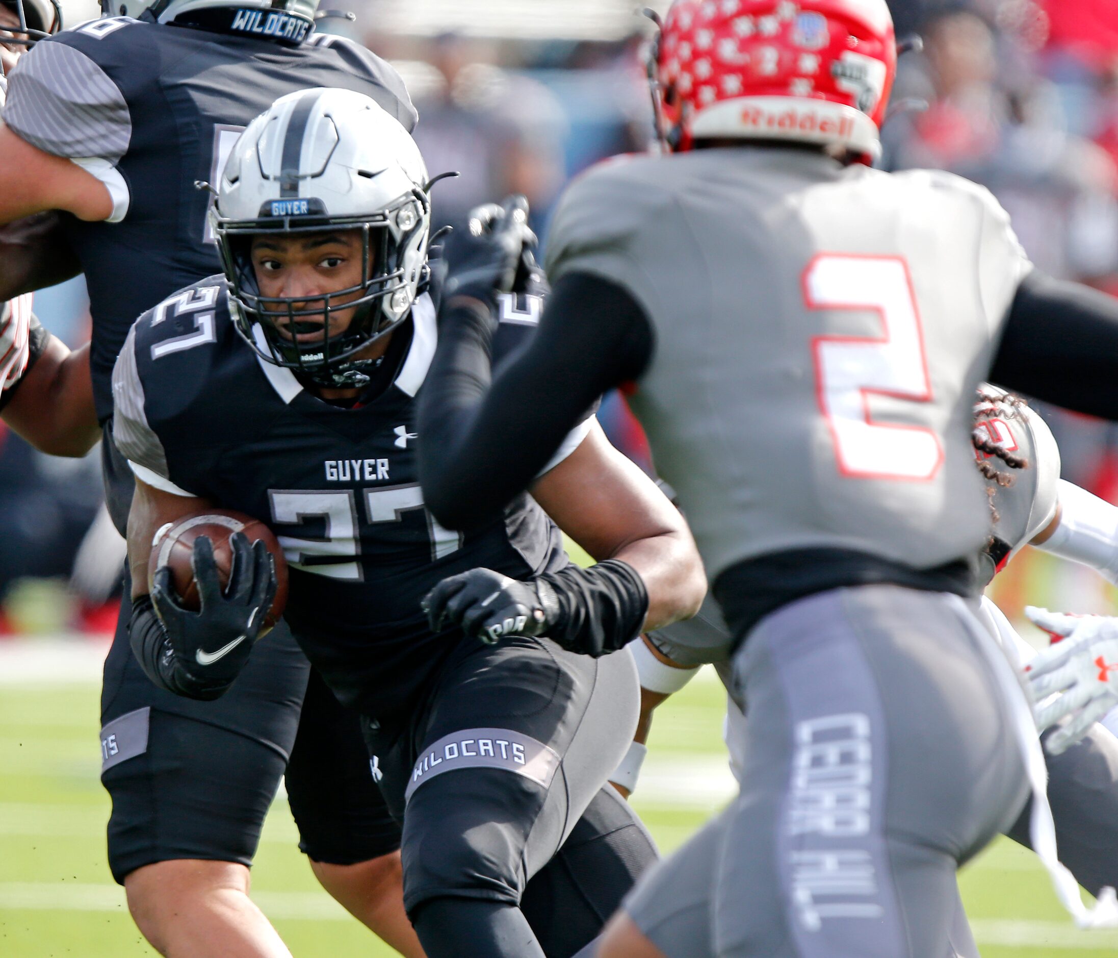 Denton Guyer High School running back Byron Phillips jr. (27) keeps his eyes on Cedar Hill...