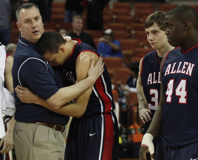 Allen head coach Jeff McCullough consoles Allen forward Jamuni McNeace (4) after they lost...