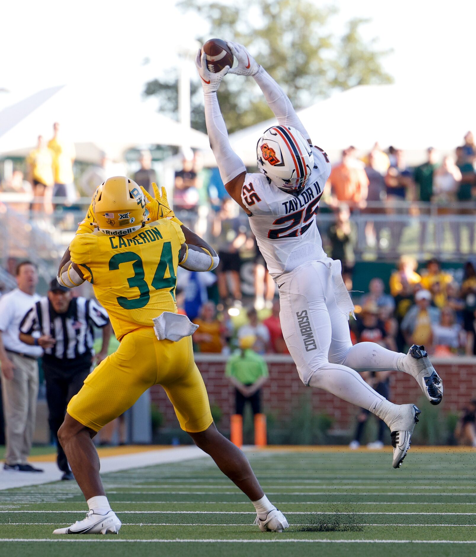 Oklahoma State safety Jason Taylor II (25) intercepts a pass intended for Baylor wide...