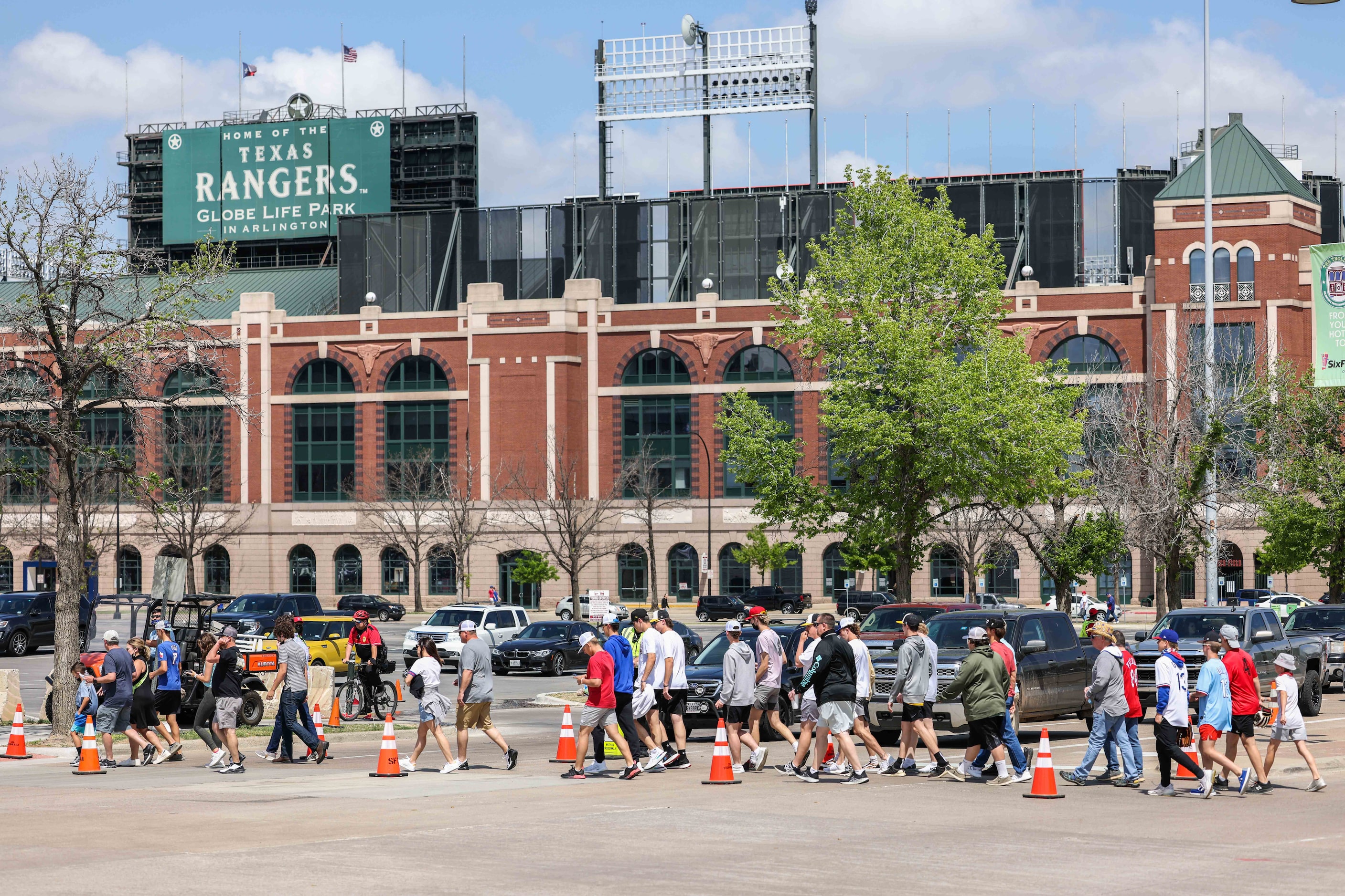 Fans walk to the Globe Life Field entrance to attend the game between Texas Rangers and...