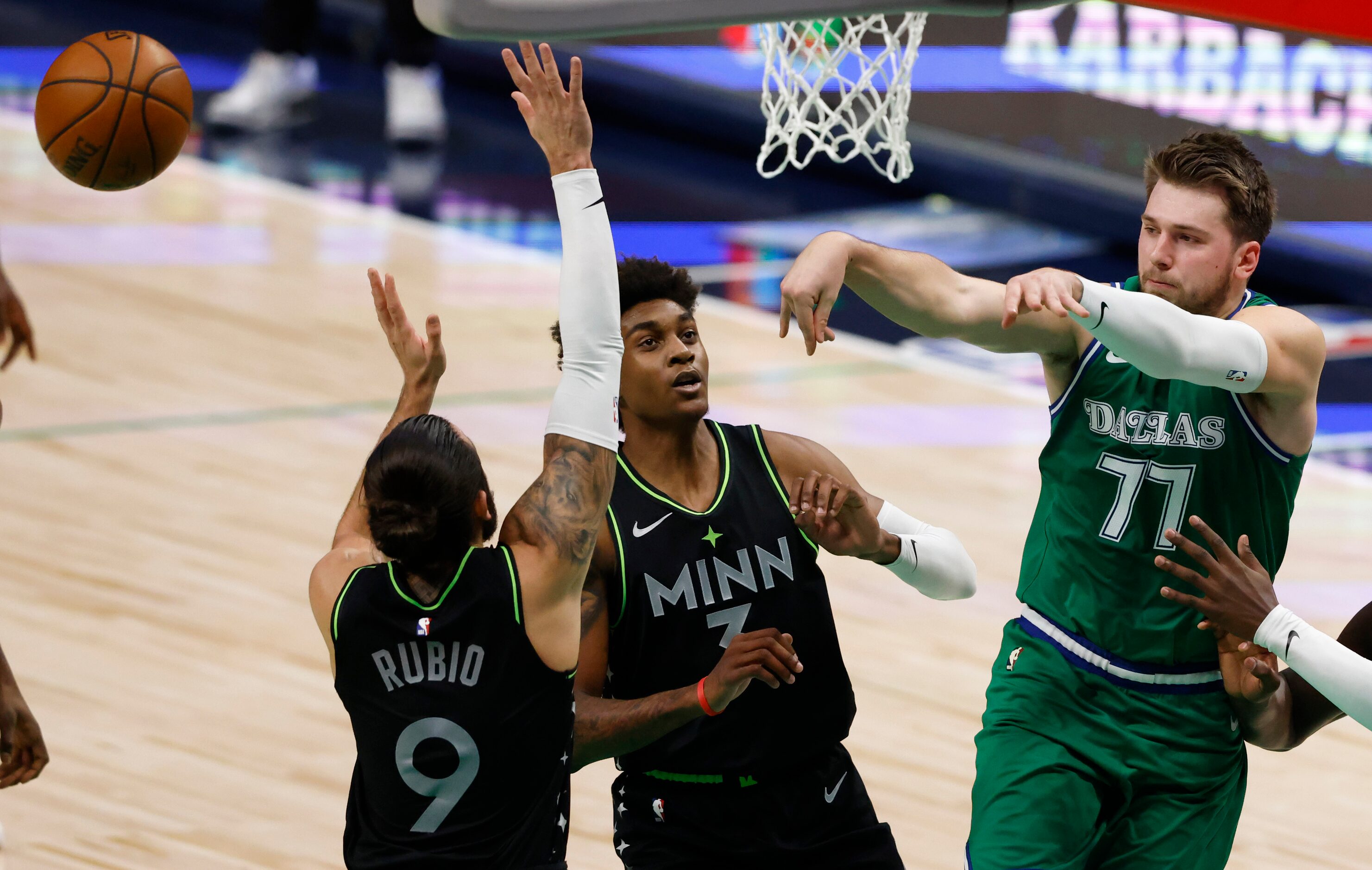 Dallas Mavericks guard Luka Doncic (77) passes the ball as he is defended by Minnesota...