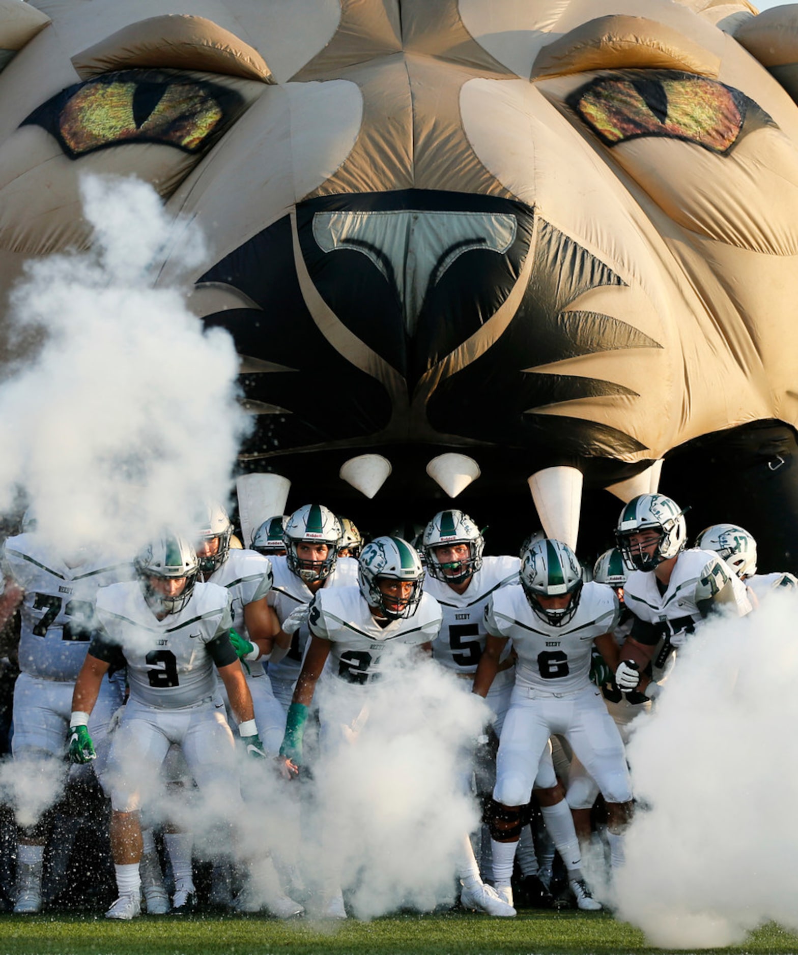 The Frisco Reedy football team takes the field through fire extinguisher blasts before...