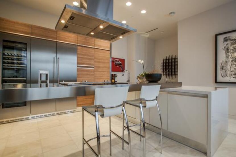 
Purchased as unit from Cantoni, the contemporary kitchen has custom cabinetry, a...