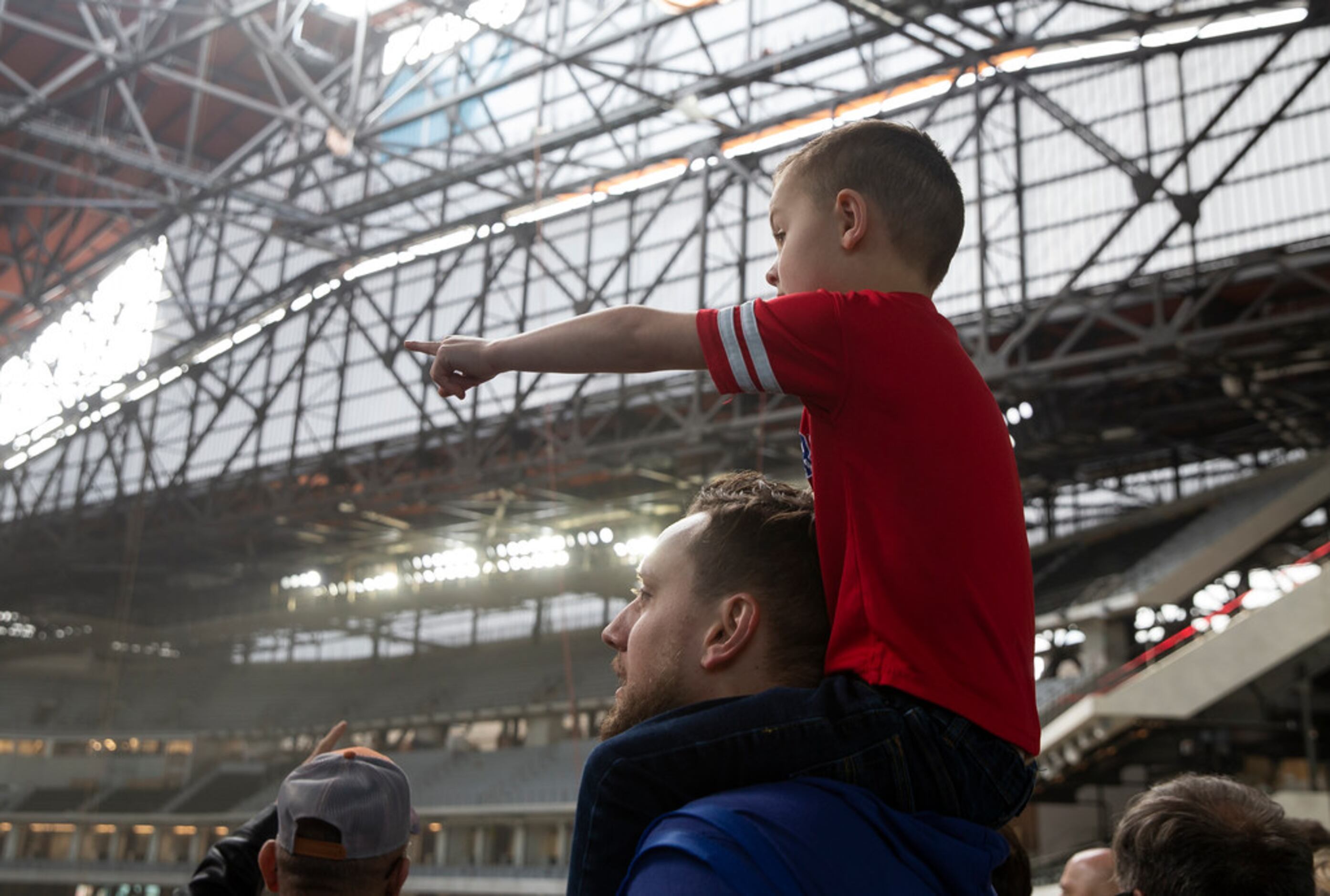Brett Albers from Fort Worth holds his son Adrian Shahan, 5, as they check out the Globe...