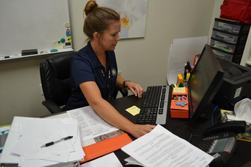 
Stacy Guerra, director of the Middle Years Programme, looks up information Aug. 11, the...