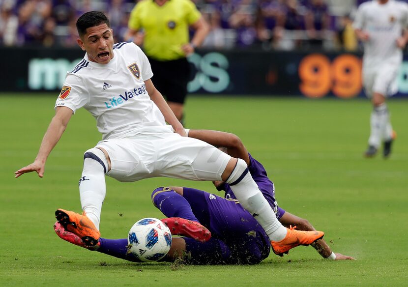 Real Salt Lake's Joao Plata, left, goes down after Orlando City's Mohamed El-Munir went for...